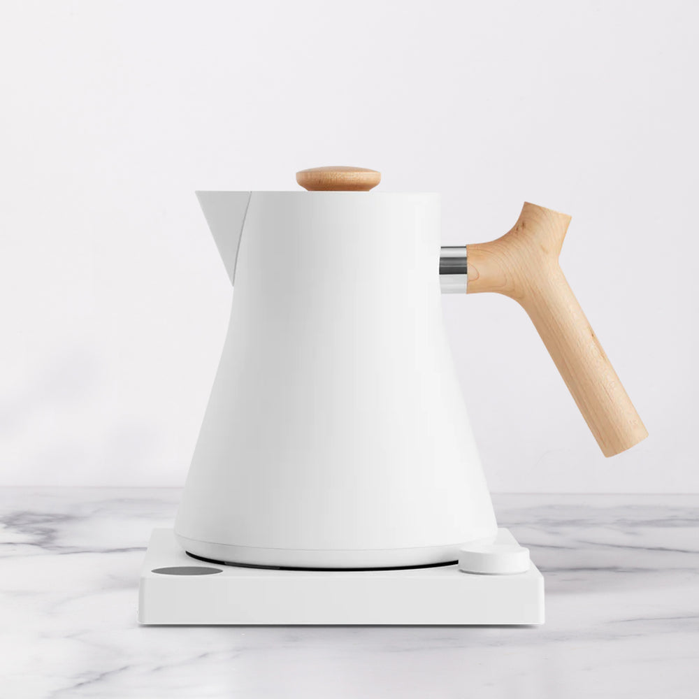White electric tea kettle with light wooden handle.