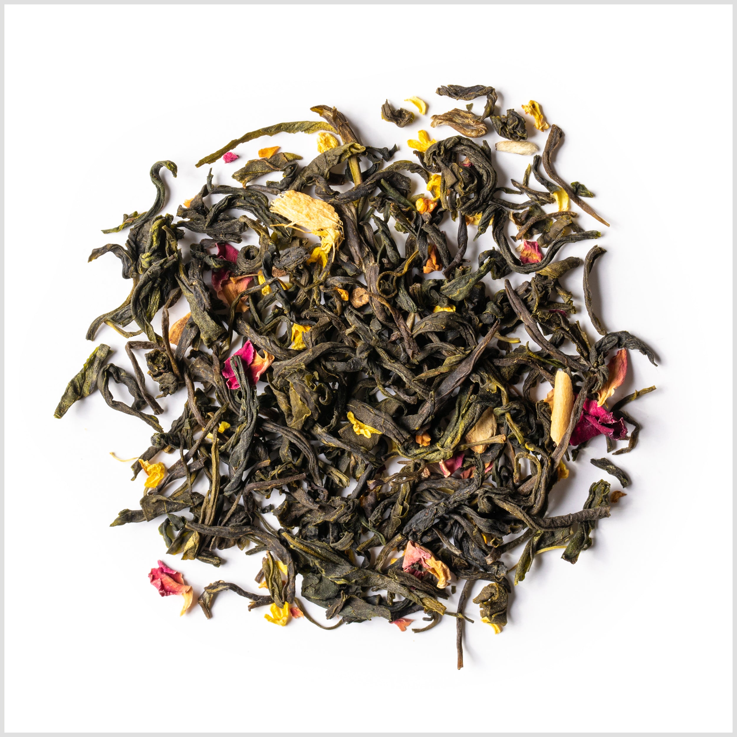 Circular pile of loose green tea with ginger, rose petals and osmanthus