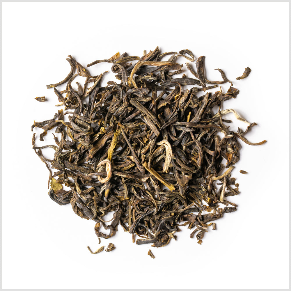 Circular pile of loose-leaf Jasmine Silver Tip green tea. 