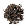 A small pile of full leaf Lord Bergamot black tea on a white background.
