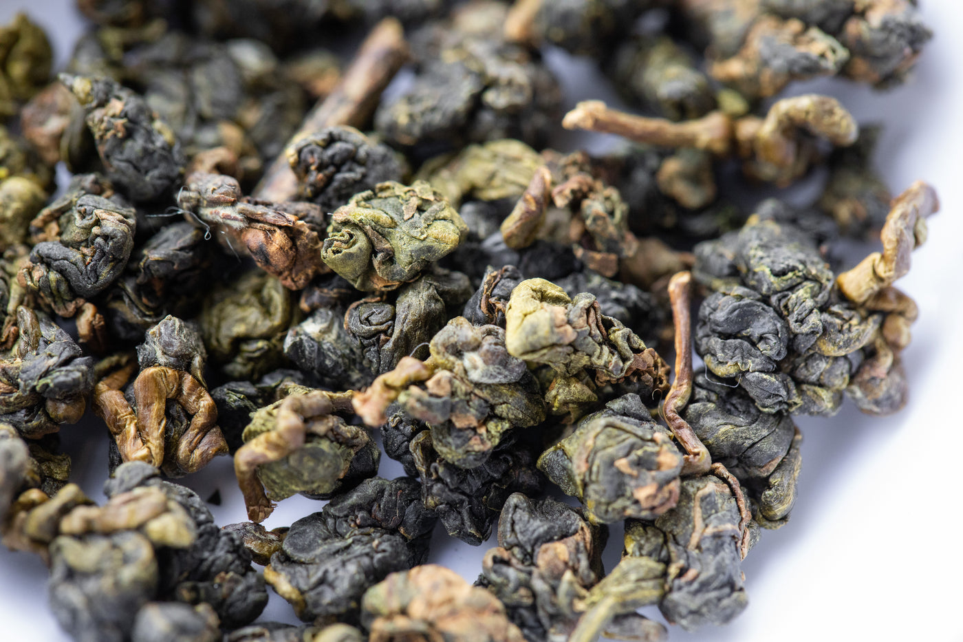Up close view of rolled oolong tea to show clumped, hand rolled texture.