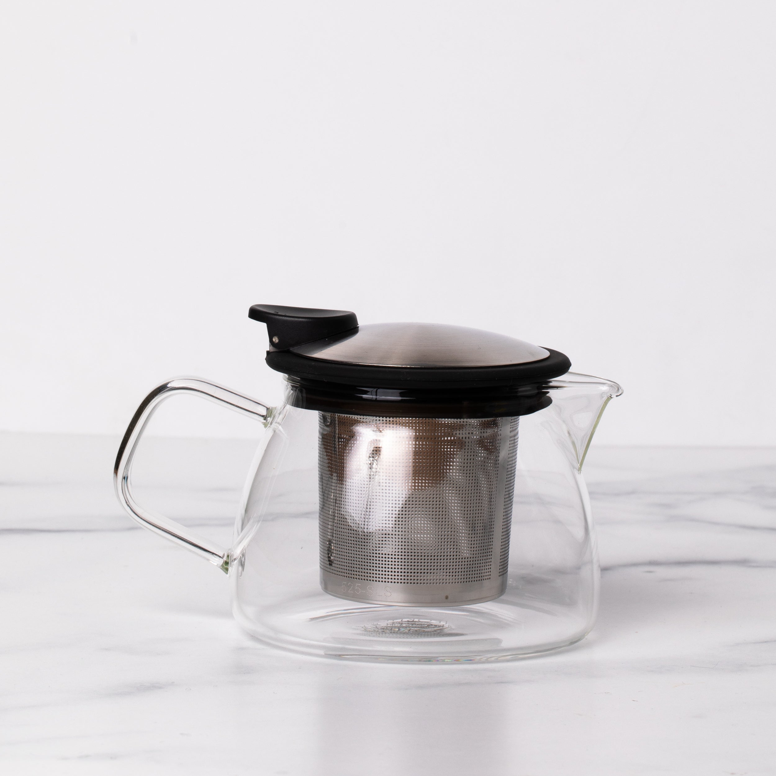 Glass teapot with stainless steel and black lid with spout and handle.