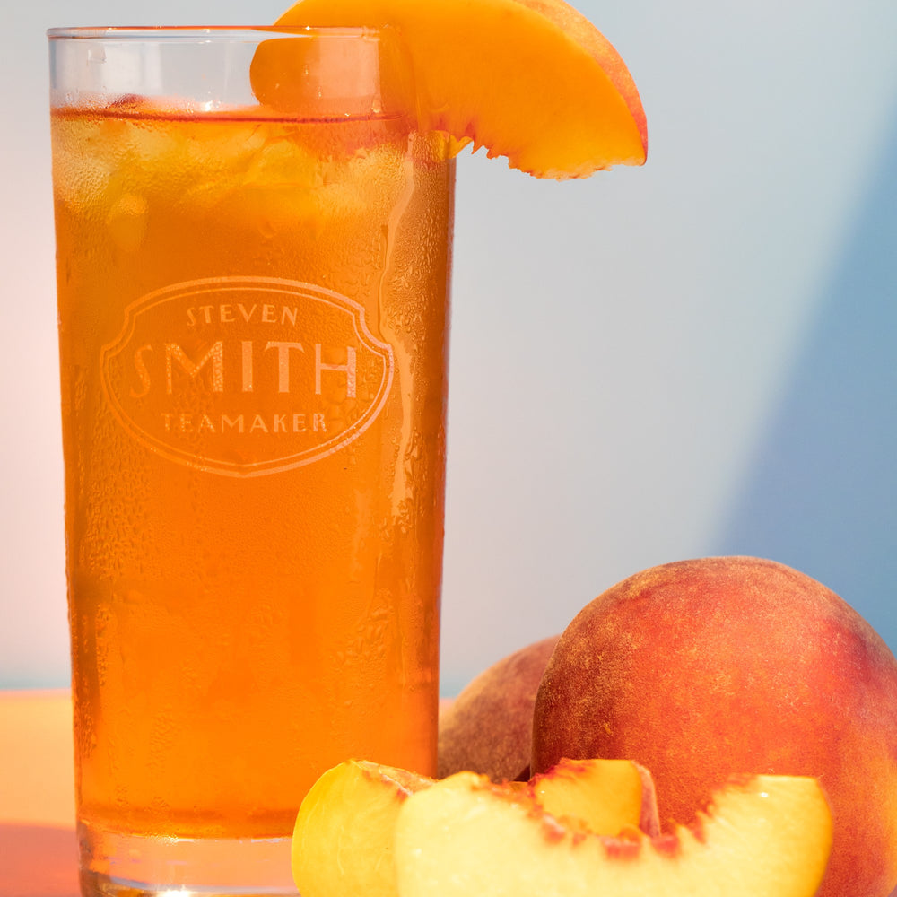 Glass of Ginger Peach iced tea with slice of peach.