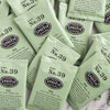 A pile of overwrapped sachets of Fez green tea.