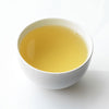 Ceramic white cup filled with Fez green tea.