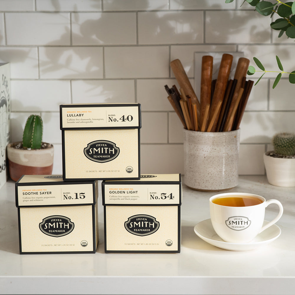 Three cream cartons of tea in a kitchen setting.