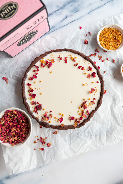 Lover's Leap chocolate tart with rose petal garnish and a pink box of Lover's Leap black tea.