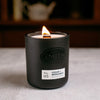Cedar and bergamot candle burning with wooden wick.