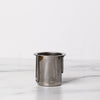 Stainless steel circular strainer with holes and two handles that are closed.
