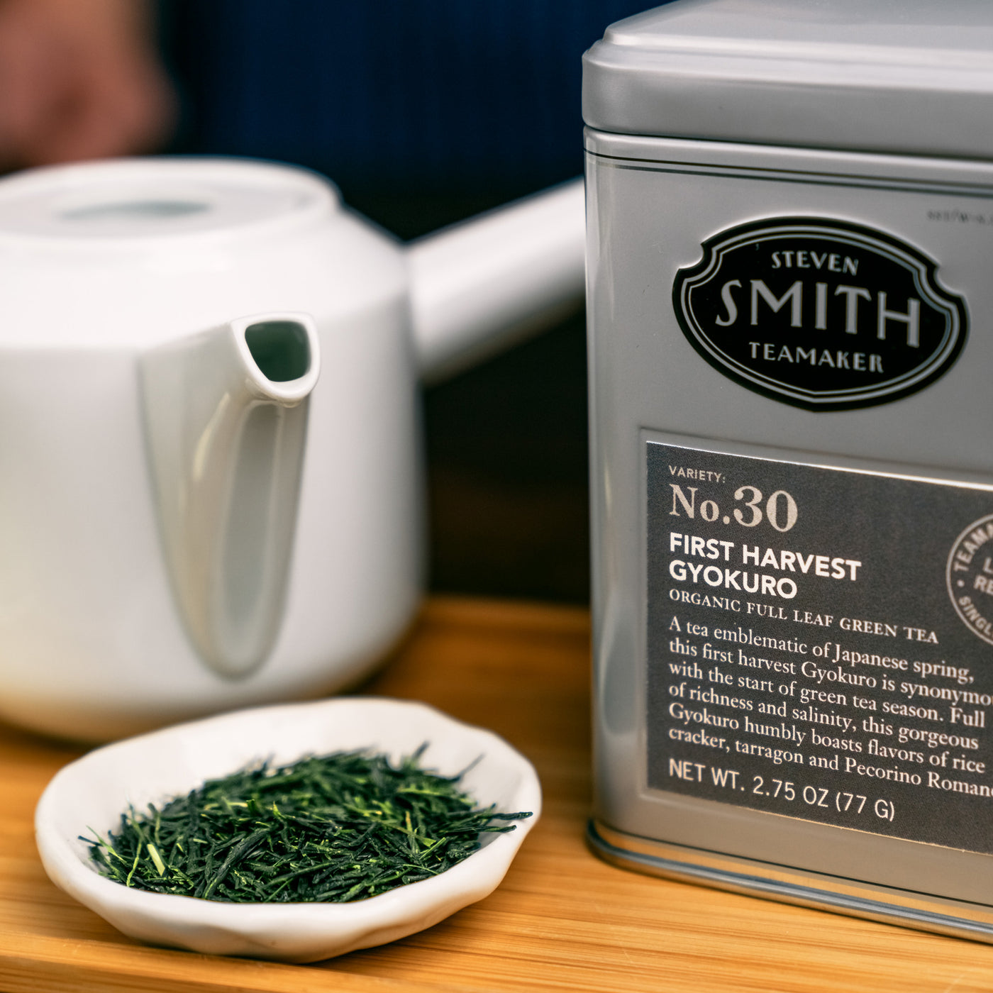 Close up view of tin of First Harvest Gyokuro beside a small bowl of loose Gyokuro tea and a Japanese-style teapot.