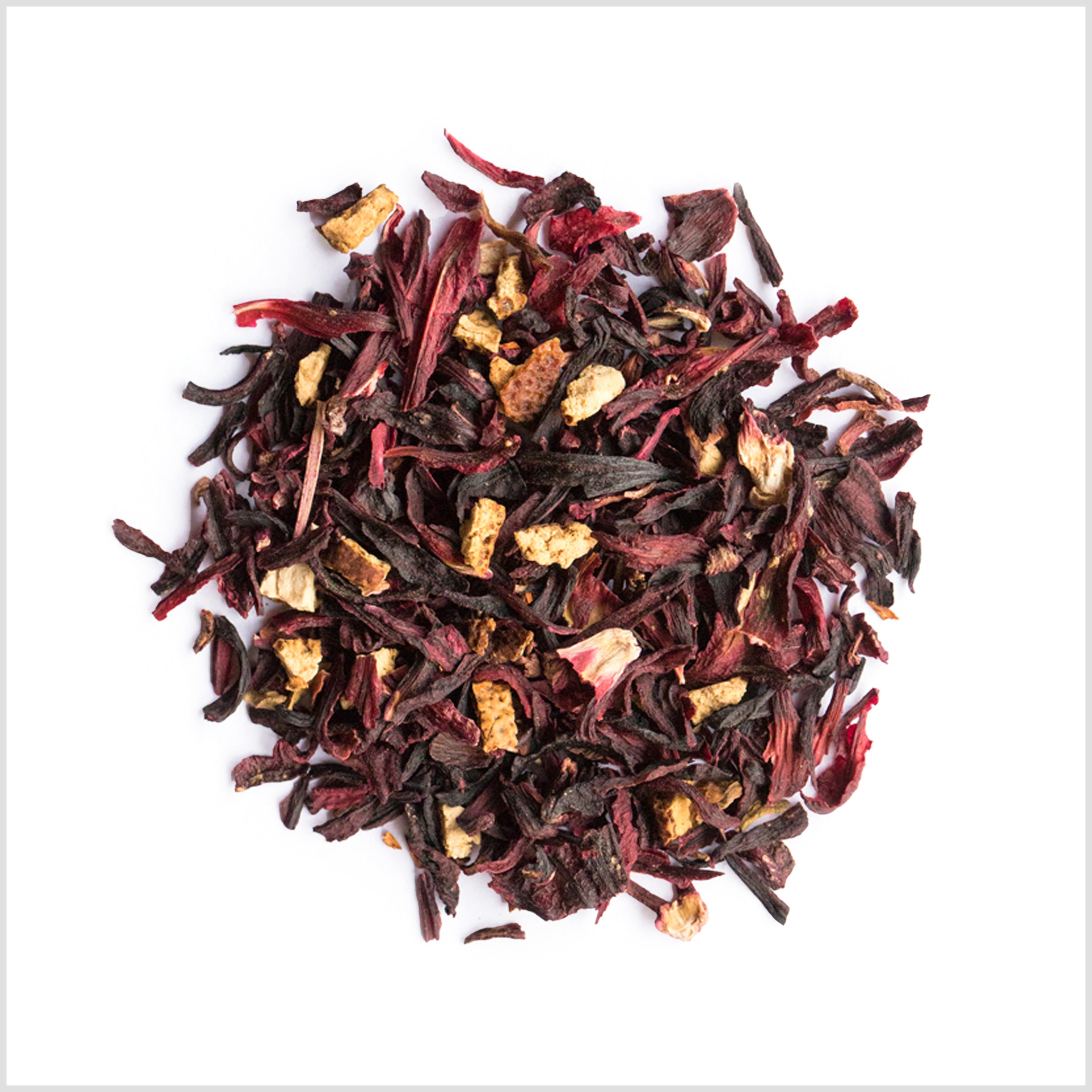 Pile of hibiscus flowers, orange peel and rose petals.