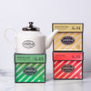 White teapot with 'Smith Tea' and three holiday cartons on a white background