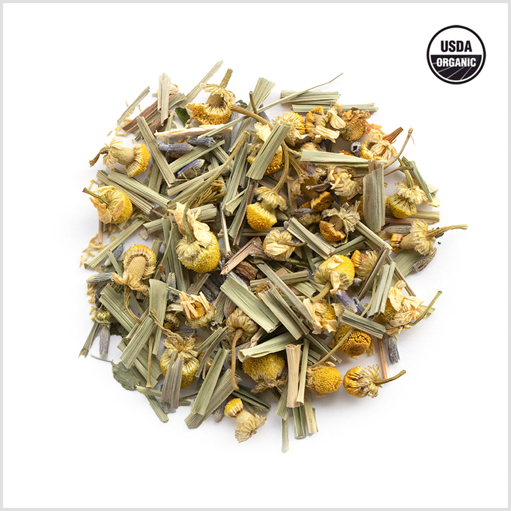 Circular pile of chamomile buds, lemongrass and lavender.