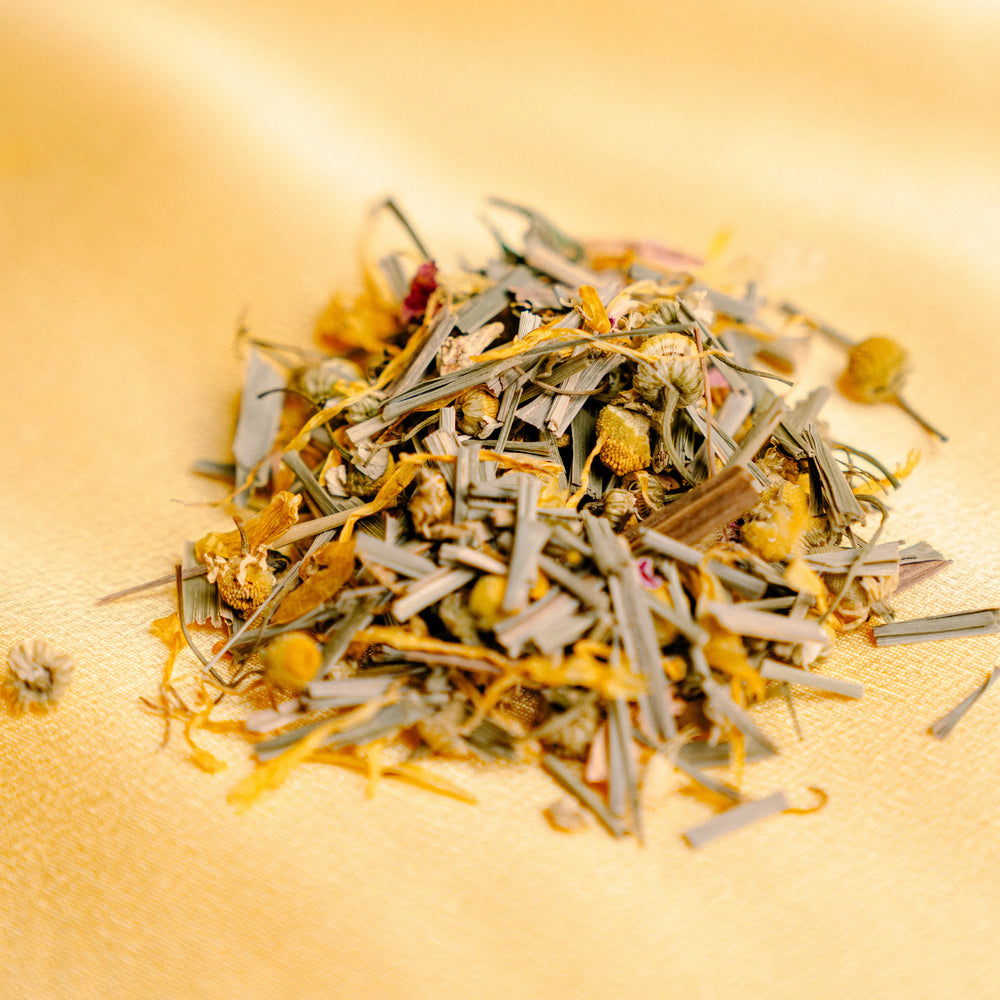 Pile of lemongrass, marigold petals, chamomile buds and ginger.