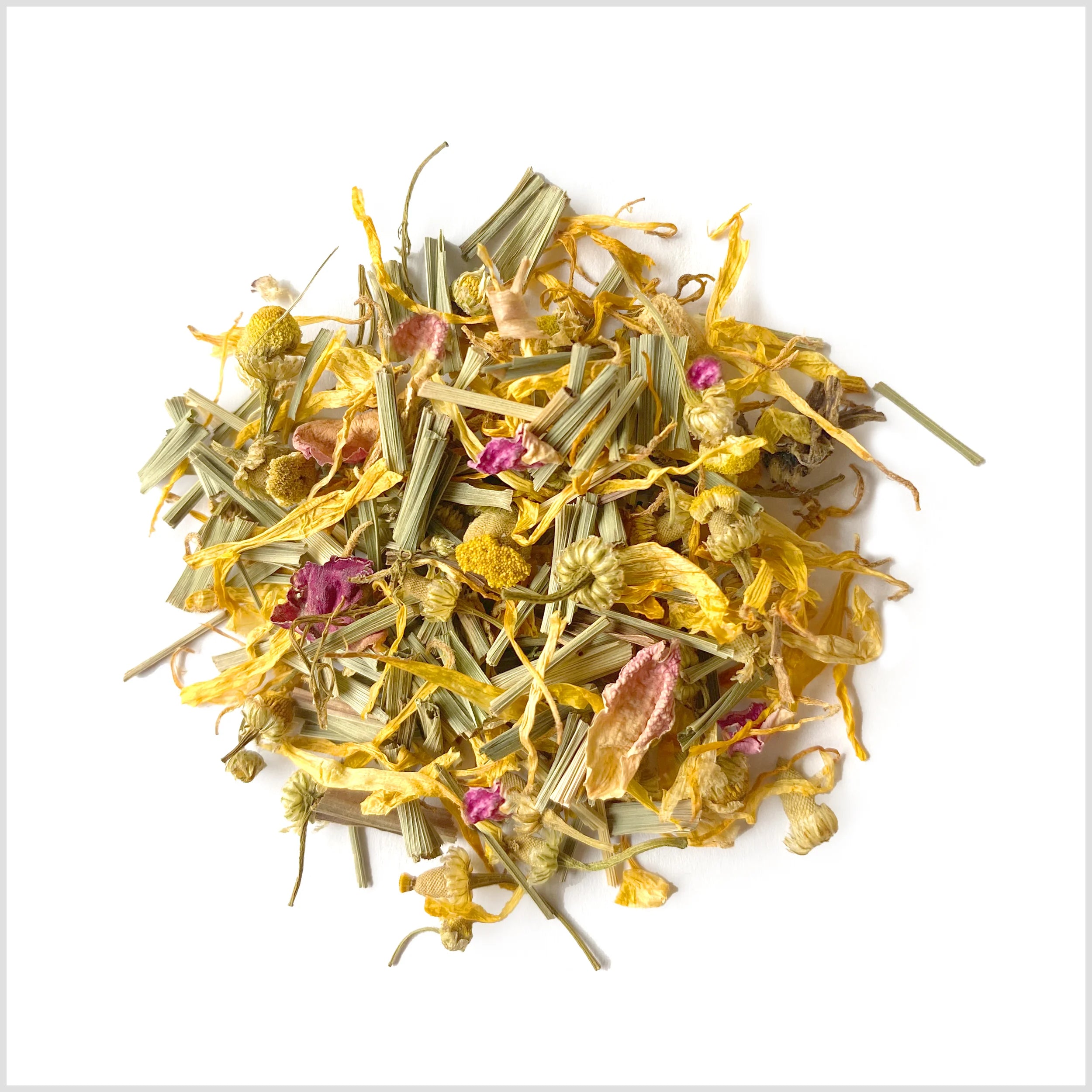 Circular pile of marigold petals, rose petals, chamomile petals, lemongrass and ginger.