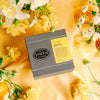 Grey box of Marigold tea with yellow label. 