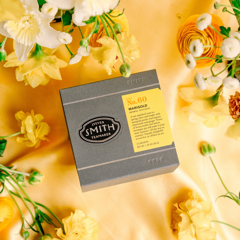 Grey box of Marigold tea with yellow label. 
