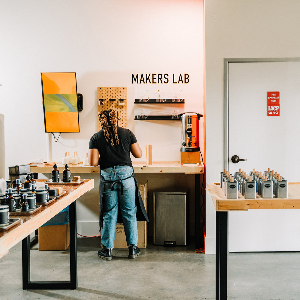 Person in a room making candles.