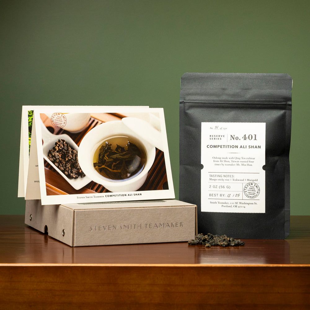 Black bag with white label on wood table.