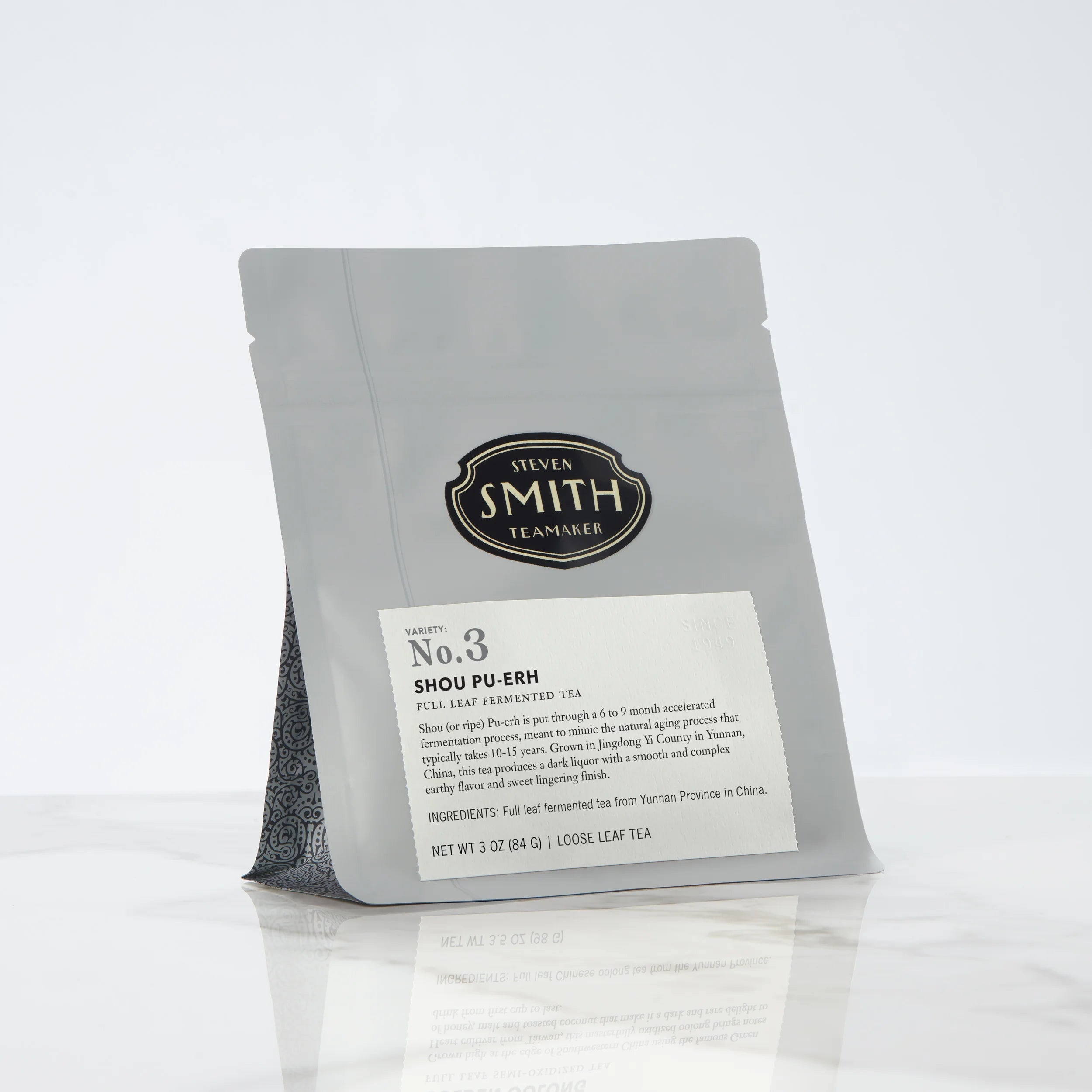 Gray bag of loose leaf tea with Smith shield and Shou Pu-erh label