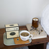 Night stand with tray of Lullaby box and tea cup.