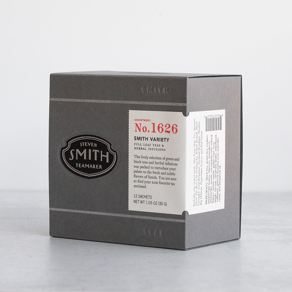 Grey box with embossed Smith logo and white label on marble table.